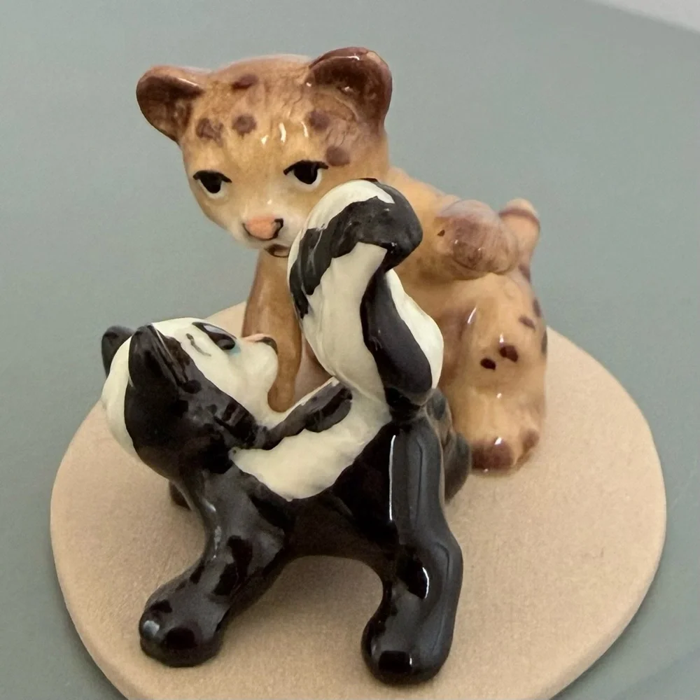 Vintage retired Hagen Renaker bobcat and skunk babies on base